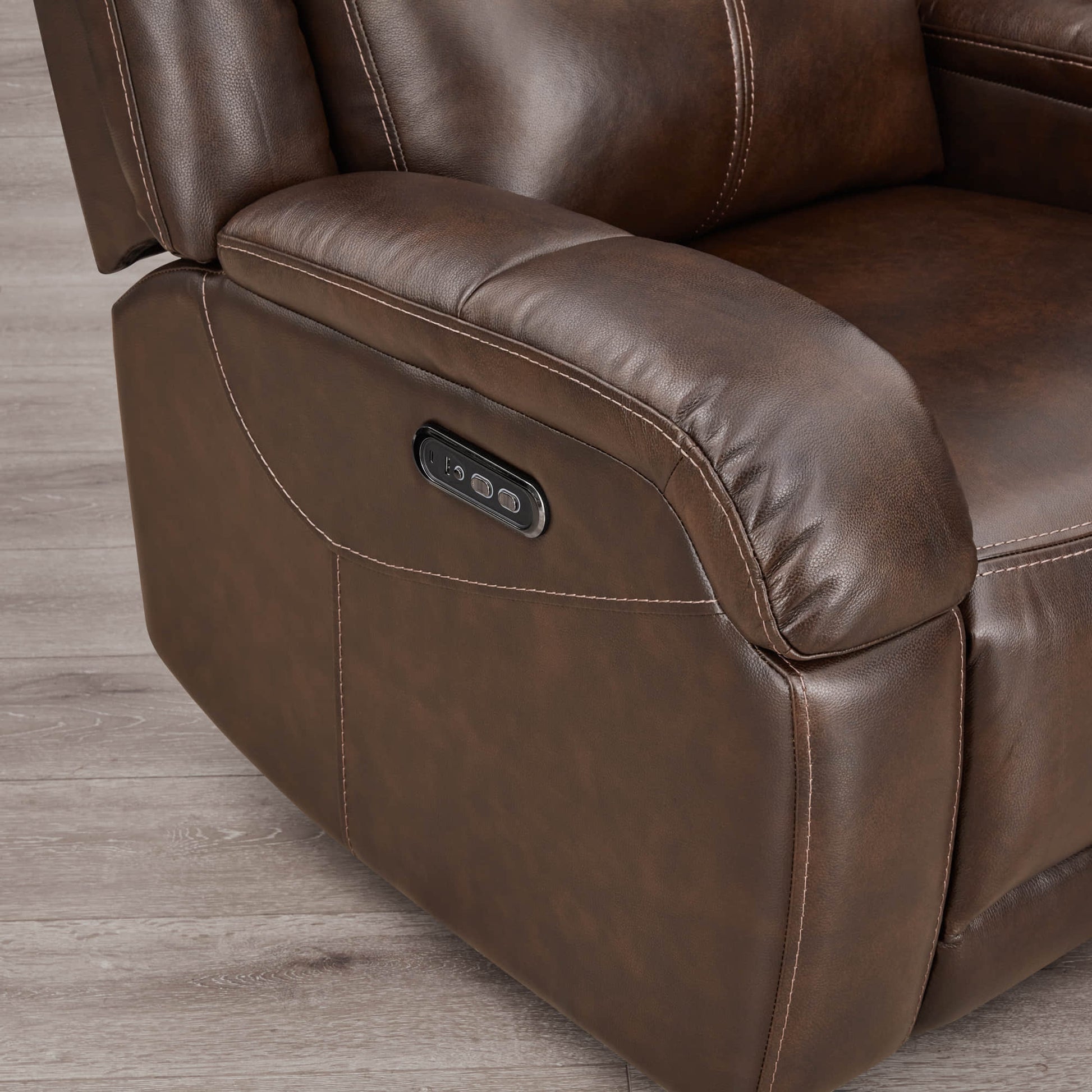 Close-up of Isaac Wall Hugger Recliner's power control in rich brown leather - CHITA Living