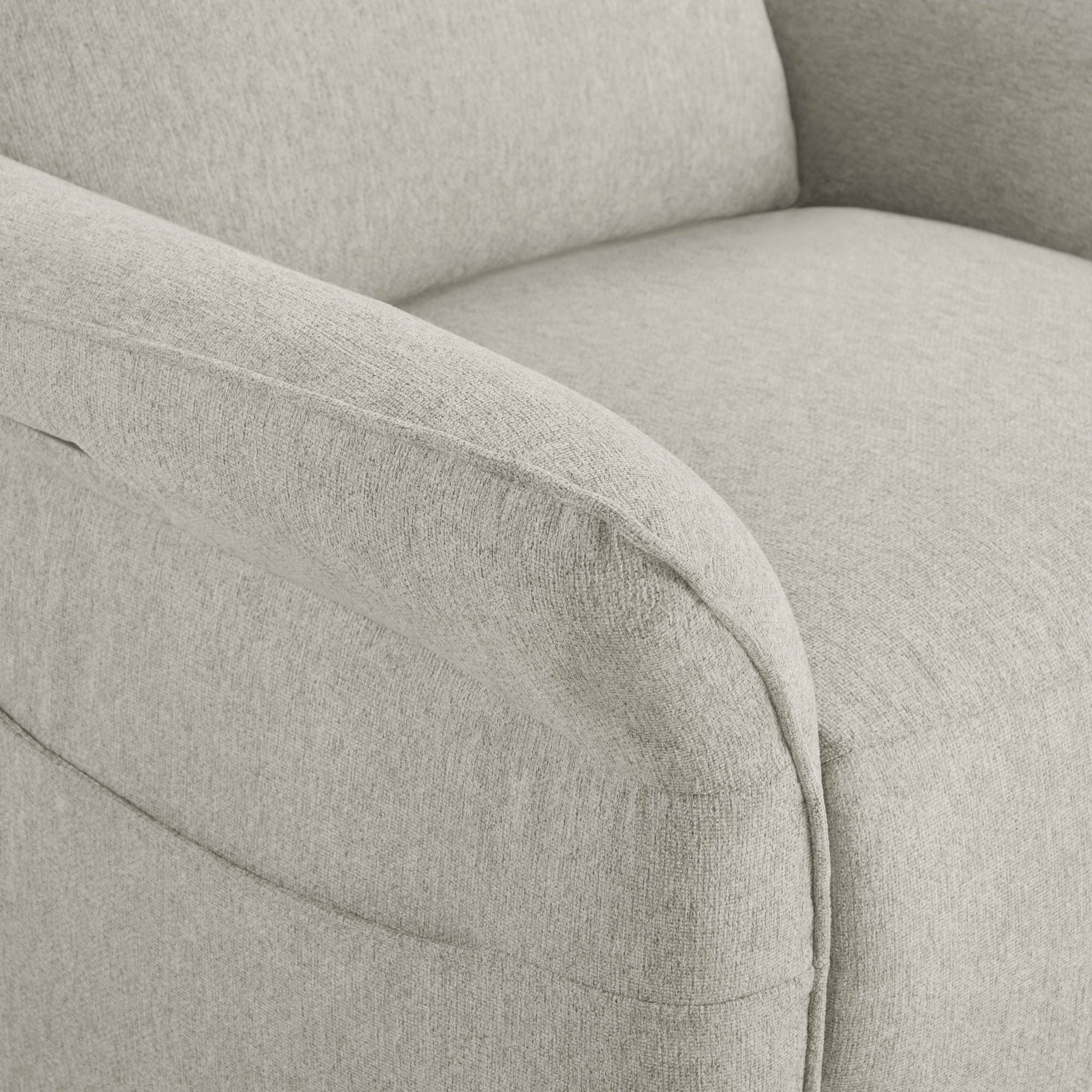 Close-up of light beige power recliner's curved armrest with quality upholstery.