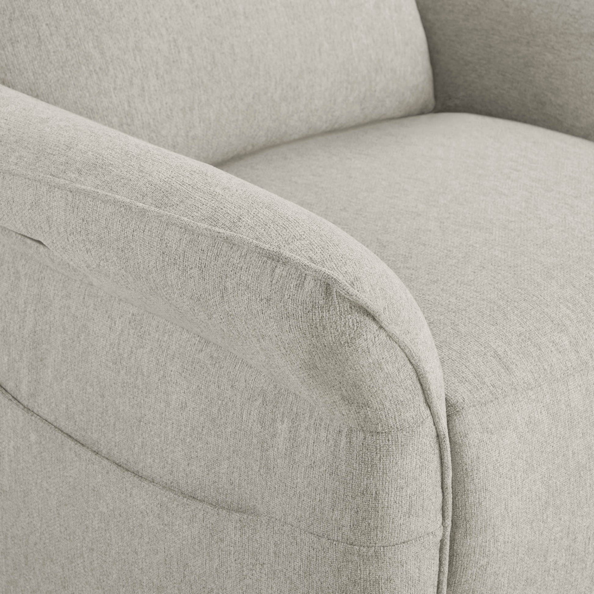 Close-up of light beige power recliner's curved armrest with quality upholstery.