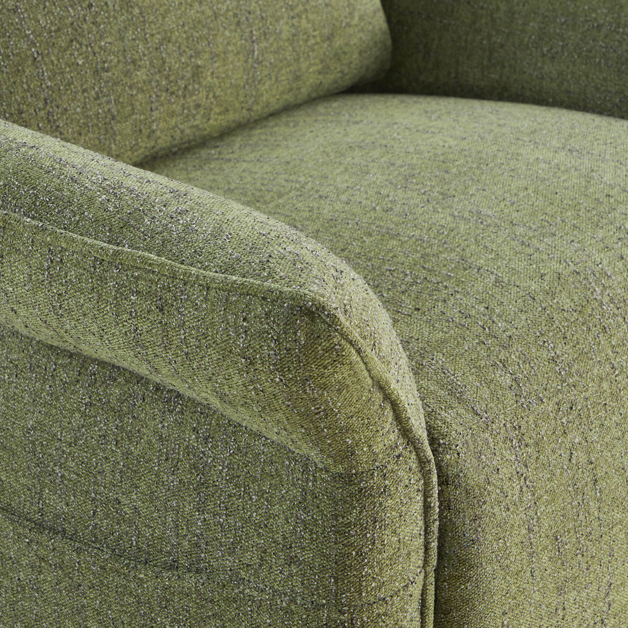 Detail shot of green power recliner's arm cushion showing textured fabric.
