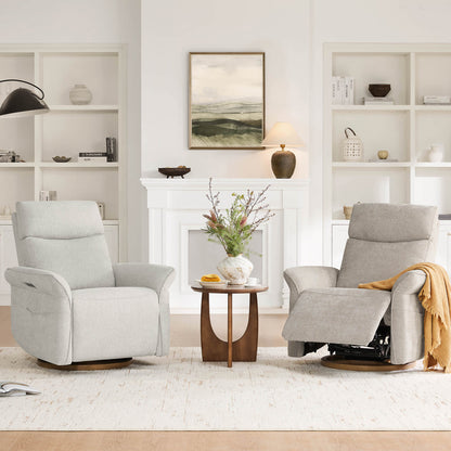 Two light grey swivel glider recliners in a cozy, bright living room setting. 