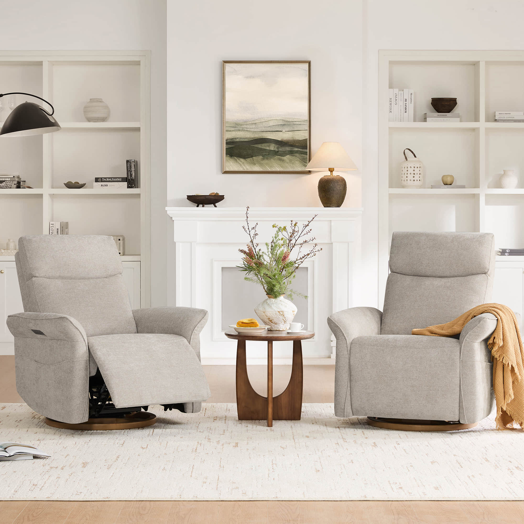 Pair of cream power recliners positioned beside stylish lamp tables for relaxation.