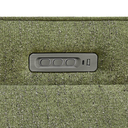 Close-up of power recliner control panel embedded in the green upholstered chair.