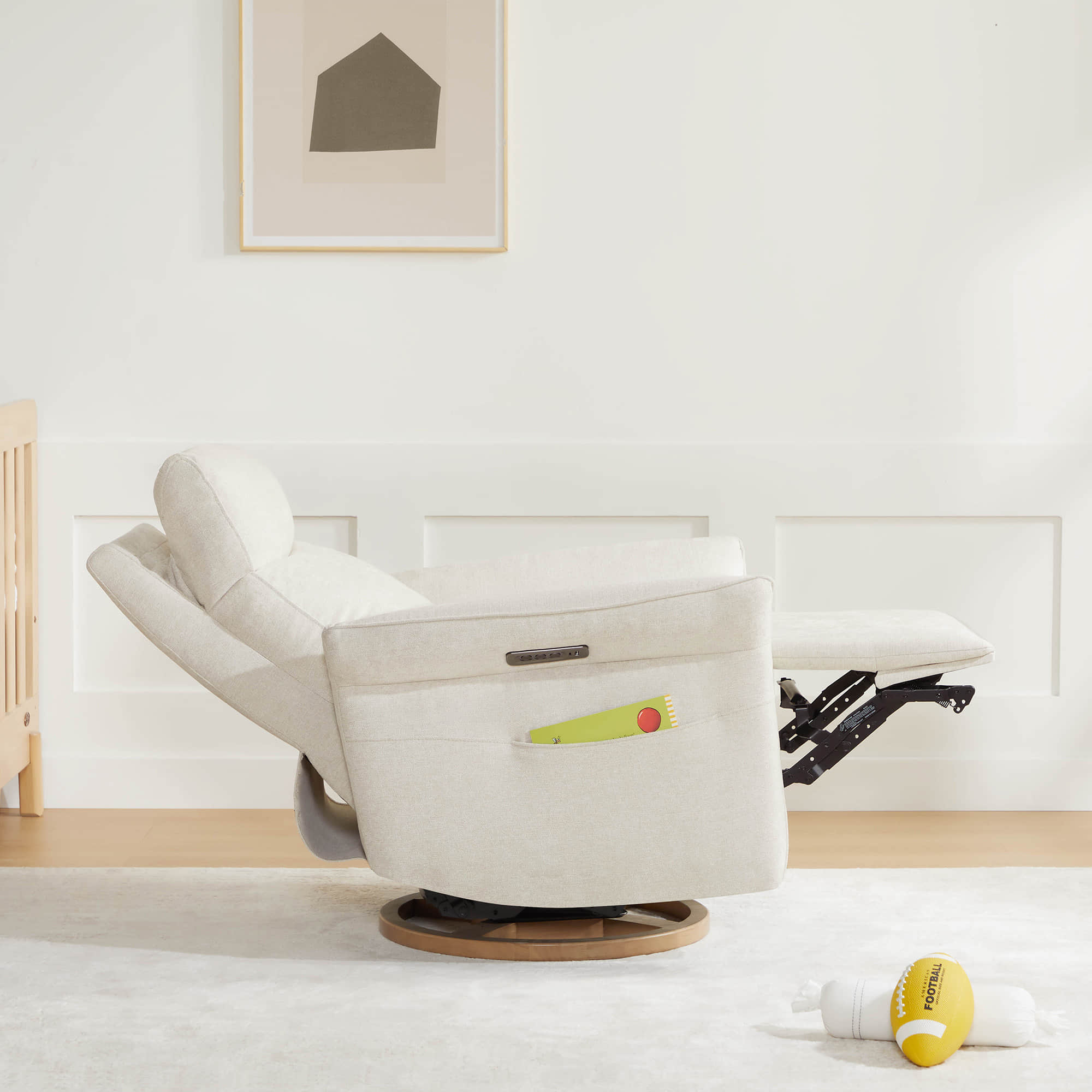 Cream power recliner with footrest extended in bright living room setting.