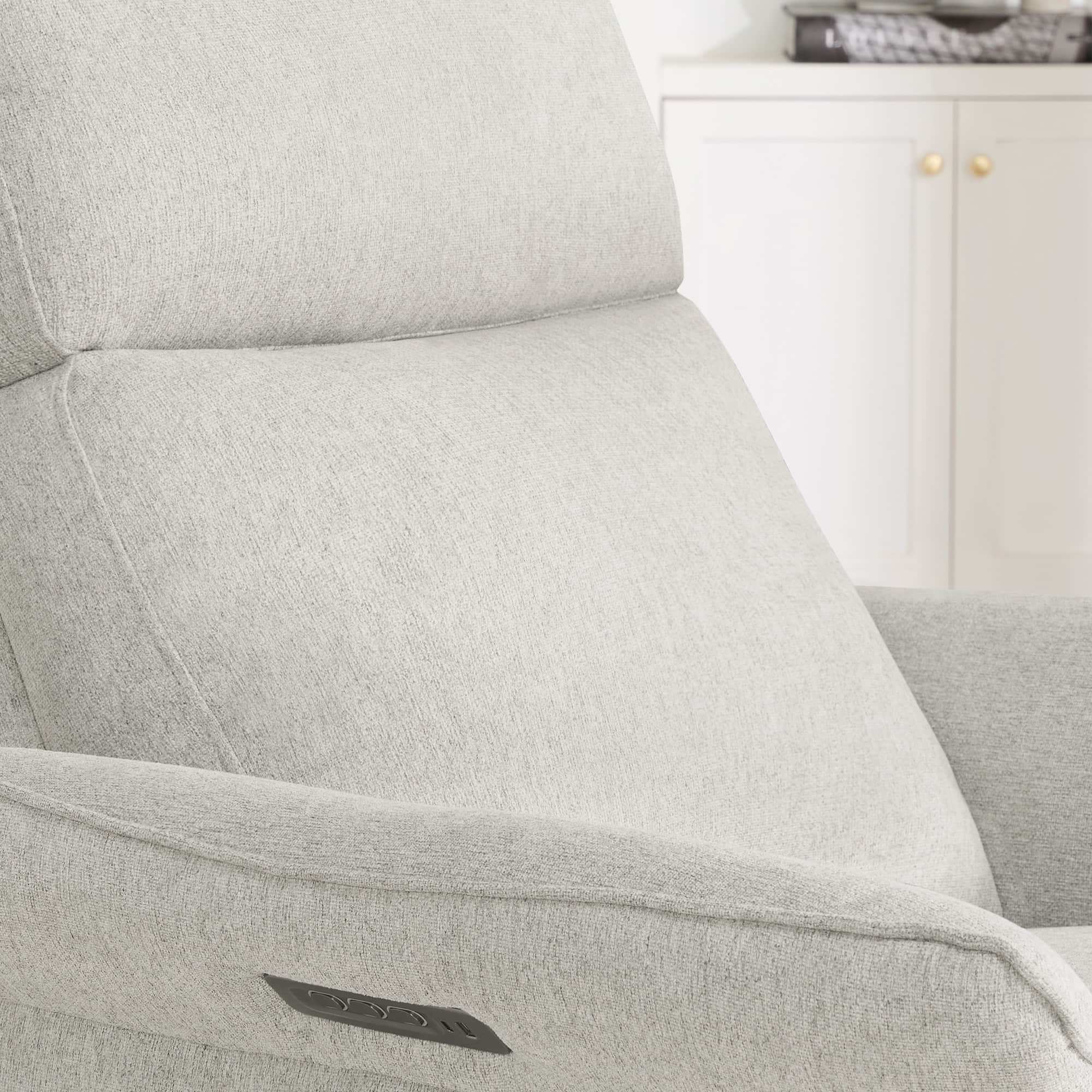 Detail of cream power recliner's armrest revealing quality upholstery craftsmanship.