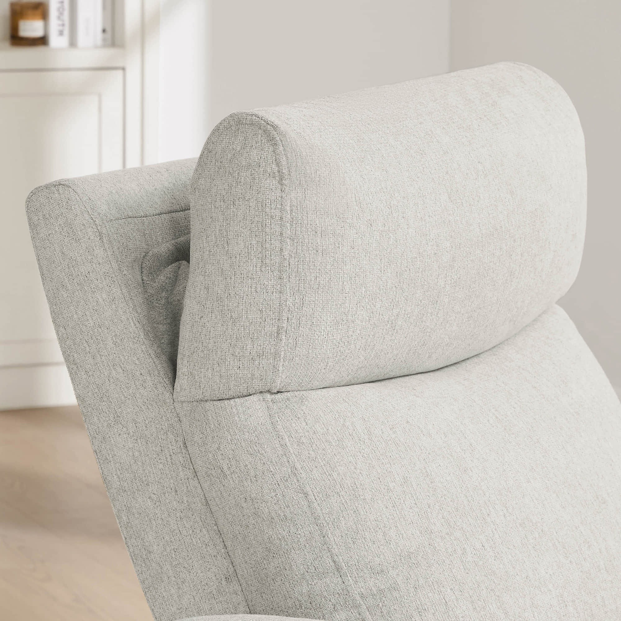 Close-up of power recliner's plush headrest showcasing premium cushioning details.