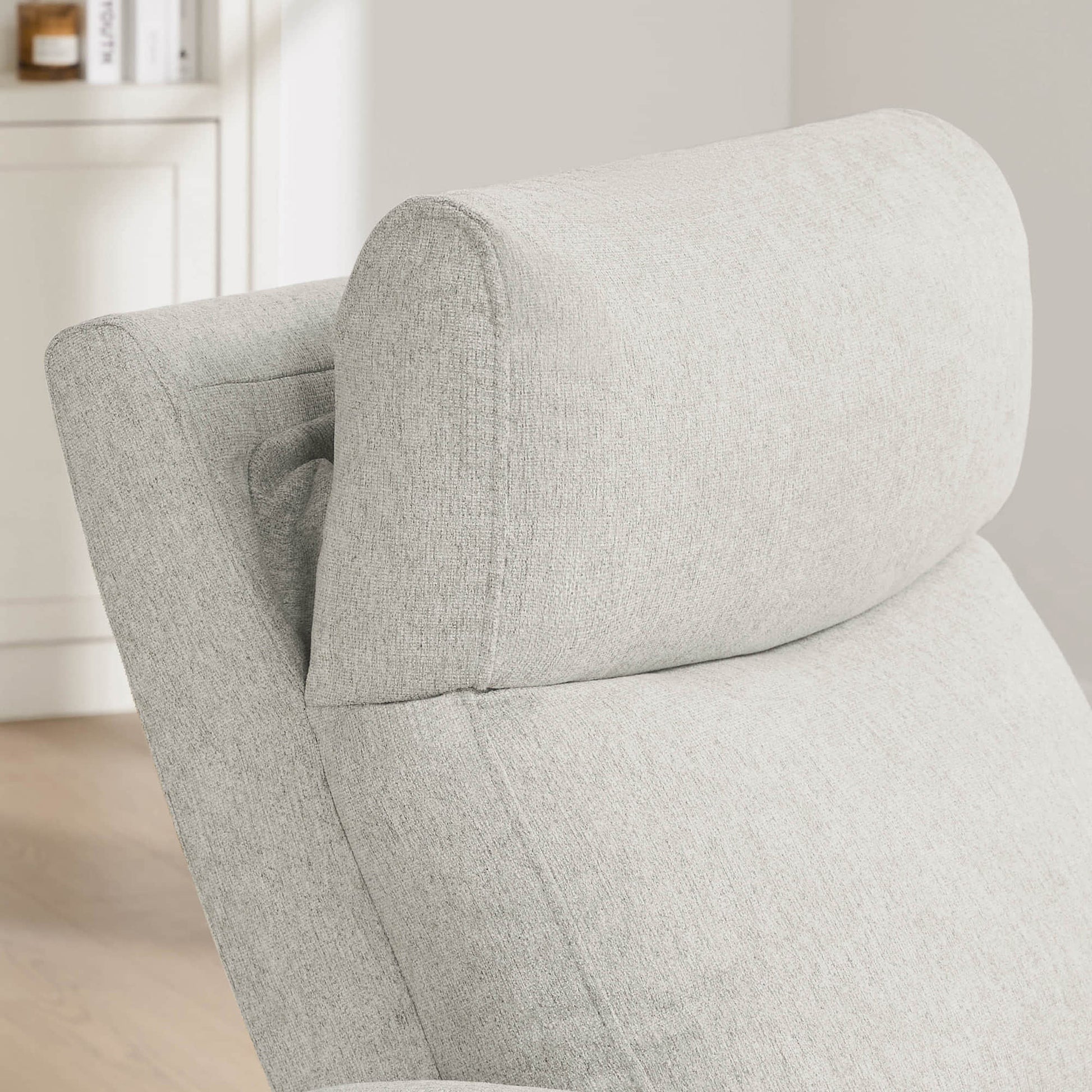 Close-up of power recliner's plush headrest showcasing premium cushioning details.