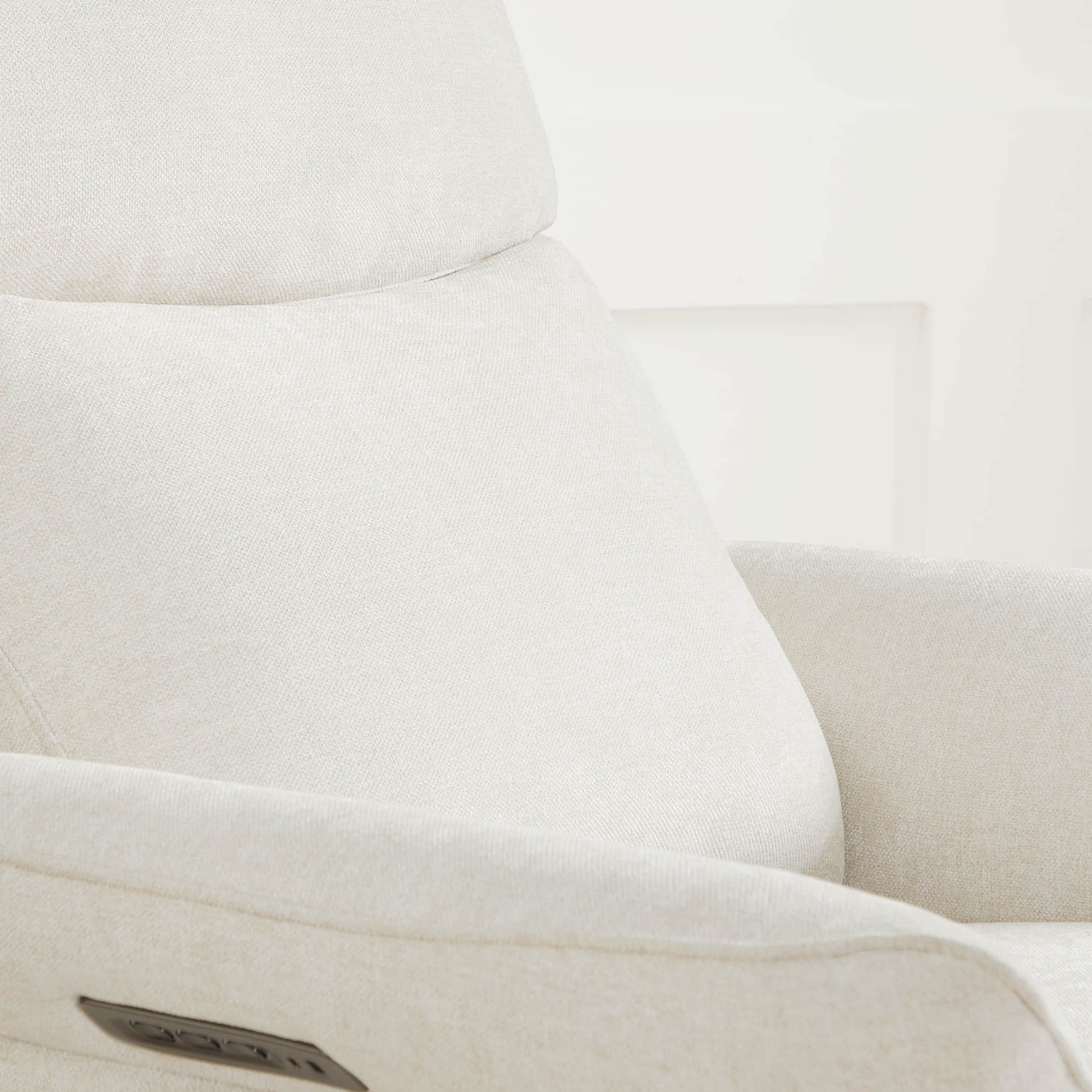 Detail of cream power recliner's backrest cushioning and premium upholstery.