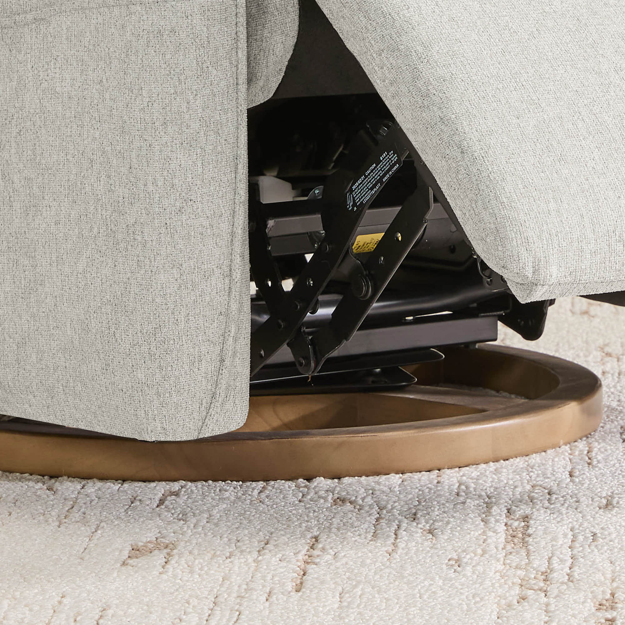 Underside view of swivel recliner base showing circular rotation mechanism.