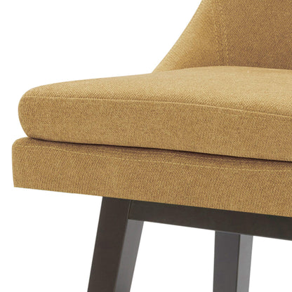 Close-up of Lissa Swivel Bar Stool with soft tan fabric seat and black wood legs - CHITA Living