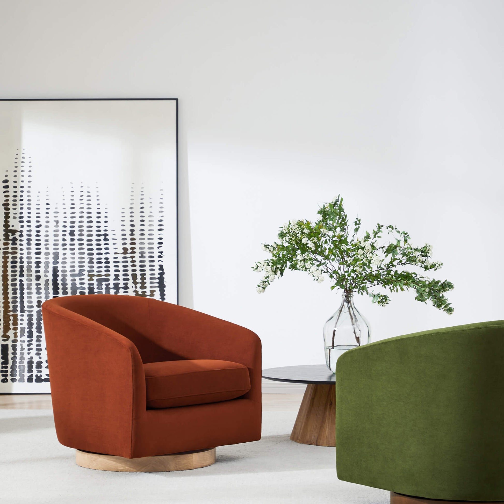 Wren Modern Swivel Accent Chair in rust color beside a side table and greenery in a modern setting - CHITA Living
