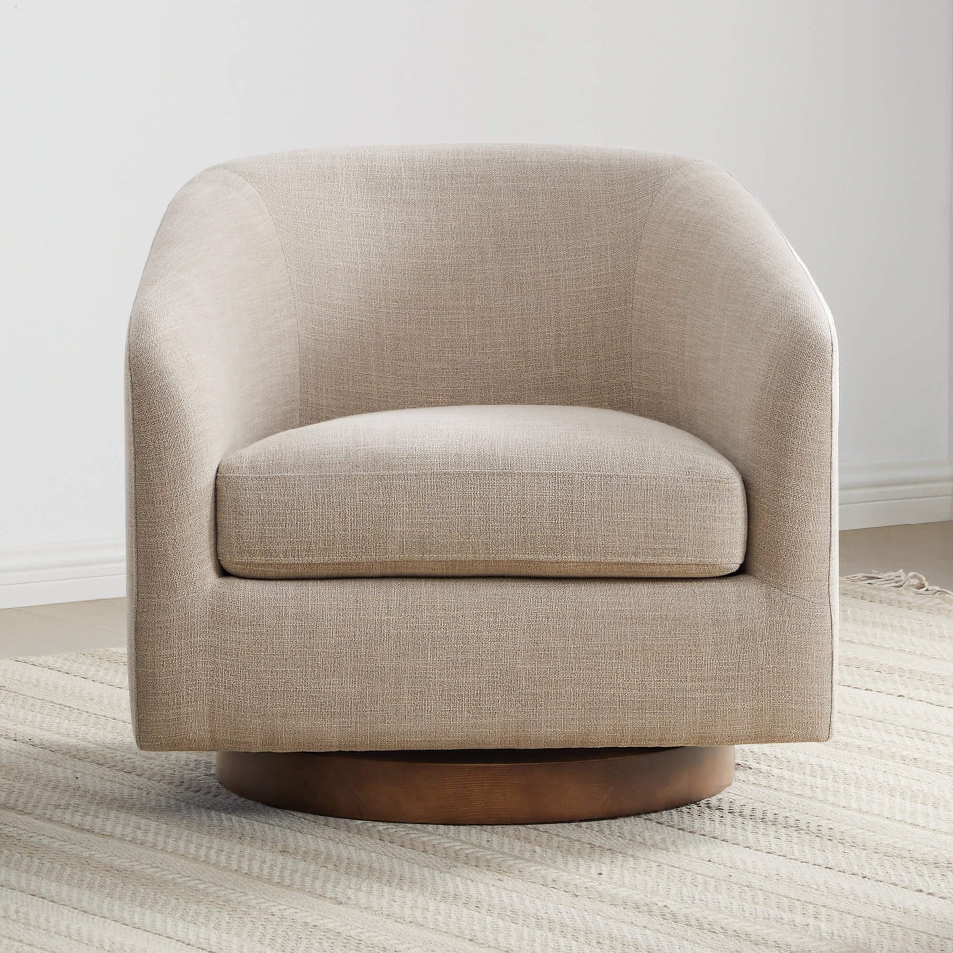 Beige Wren Modern Swivel Accent Chair with plush cushion and wood base on textured rug - CHITA Living