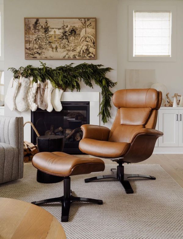 A cozy living room with a brown leather armchair and ottoman