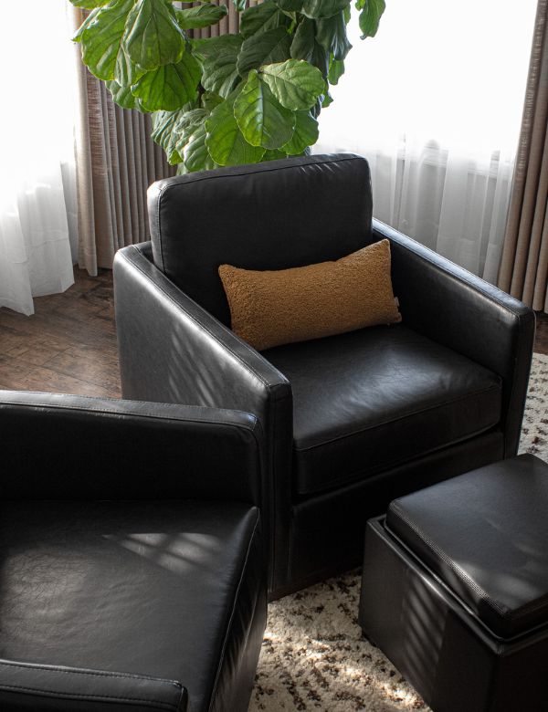A cozy seating area with black leather armchairs