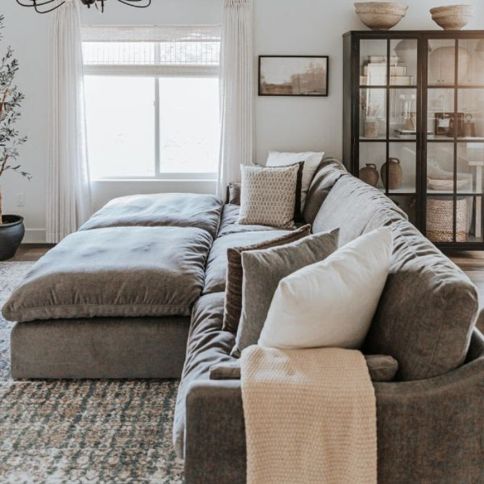 A cozy gray sectional sofa with plush cushions