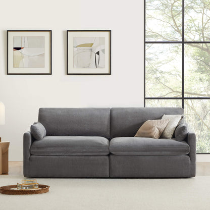 Kenna 2 Seat Modular Sofa in gray fabric, modern living room setting with decorative pillows, comfortable seating.