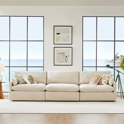 Kenna 3 Seat Modular Sofa in beige fabric with ocean view. Comfortable, deep seat, and soft cushions.